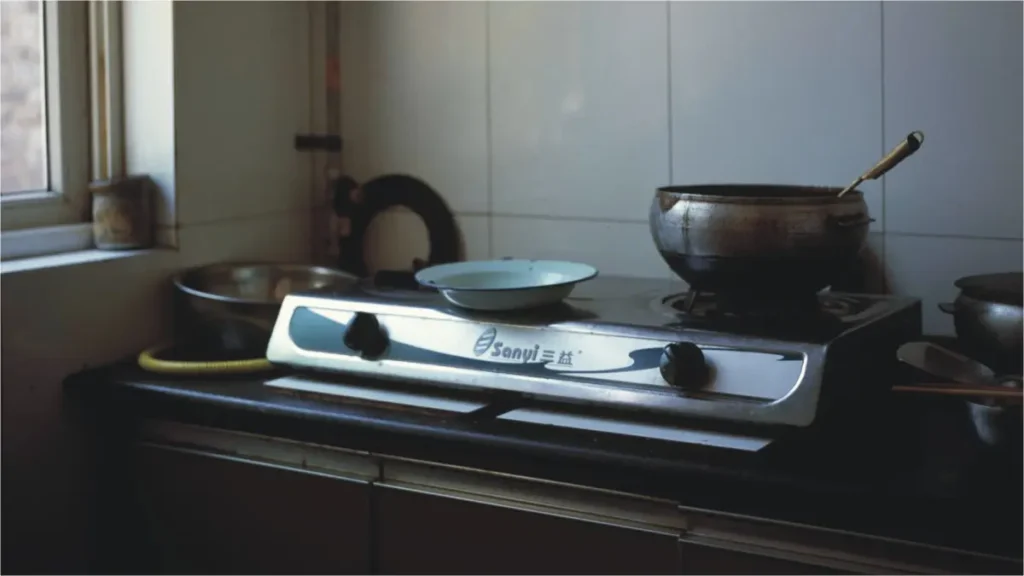 a pakistani home kitchen, stove without gas, no fire to cook food